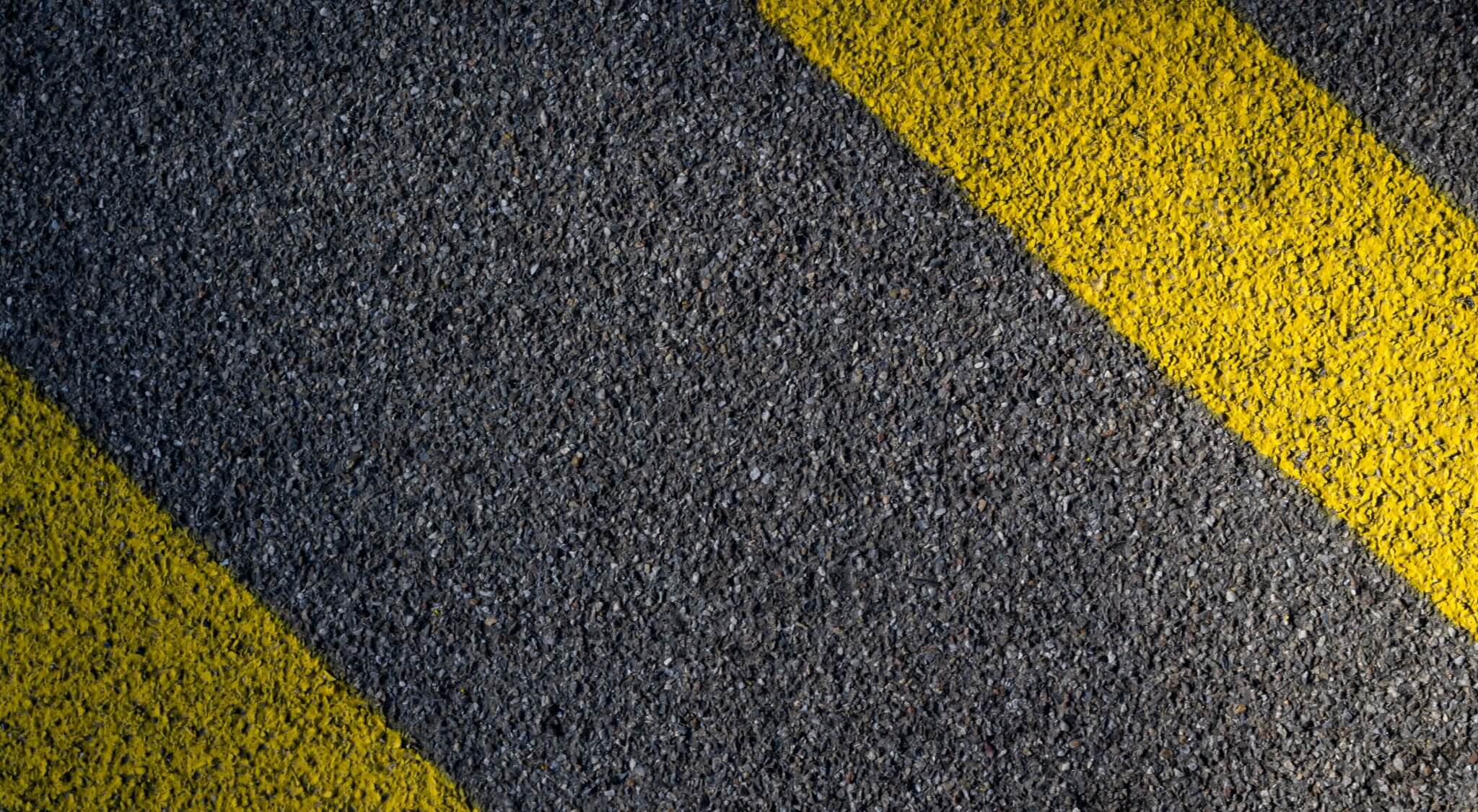 Asphalt parking lot with yellow striping